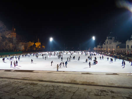 BUDAPEST, HUNGARY - NOVEMBER 19, 2016: People ice skating on outdoor ice rink by night in the City Park, in front of Vajdahunyad Castle.のeditorial素材