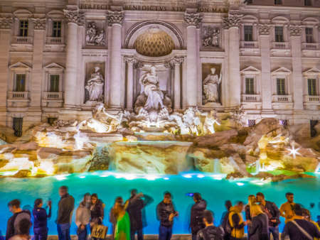 ROME, ITALY - NOVEMBER 22, 2016: People in front of the Trevi Fountain by night. Long exposure. Only a kissing couple looks like not moving.のeditorial素材