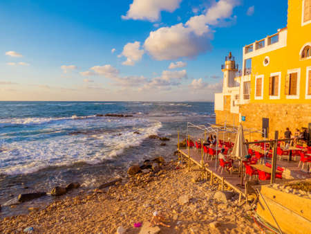 TYRE, LEBANON - MAY 21, 2017: View of the seaside at sunset with an outdoor restaurant by the sea.のeditorial素材