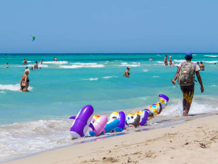 UGENTO, ITALY - JULY 15, 2017: Illegal vendor on Fontanelle Beach.のeditorial素材