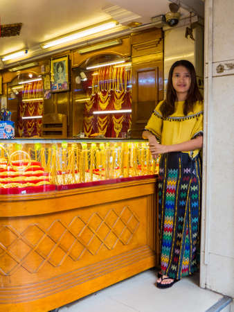 YANGON, MYANMAR - JANUARY 4, 2018: Cute Burmese girl working in a jewelery shop in the city center.のeditorial素材