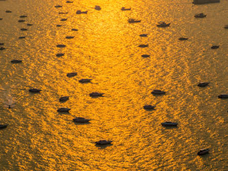 PATTAYA, THAILAND - FEBRUARY 1, 2018: Boats in the port at sunset on a magical golden sea.のeditorial素材