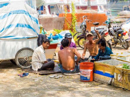 PHU QUOC, VIETNAM - FEBRUARY 8, 2018: Local people drinking and smoking near the harbor.のeditorial素材