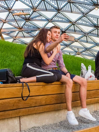 MOSCOW, RUSSIA - MAY 26, 2018: Unidentified young couple taking selfie in the new amphitheater on Zaryadye Park, opened to visitors on September 9, 2017.のeditorial素材