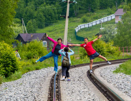 STARAYA ANGASOLKA, RUSSIA - JUNE 14, 2018: Chinese tourists posing for picture on the Circum-Baikal railroad.のeditorial素材
