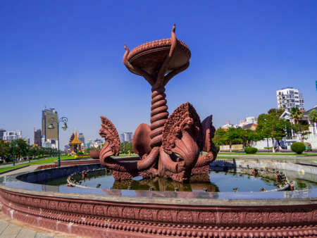 Phnom Penh, Cambodia - January 9, 2020: View of the Naga Fountain in the Preah Suramarit boulevard with the Independence Monument in the background.のeditorial素材