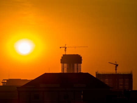 Construction cranes at sunset. In Phnom Penh, Cambodia