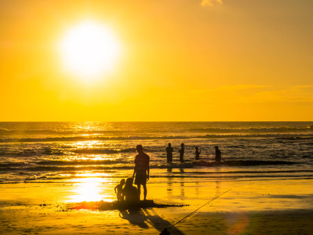 Silhouette of people at sunset on Playa Negra in Guanacaste, Costa Ricaの写真素材