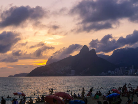 View of the Two Brothers Hill and the Vidigal favela as seen from Ipanema Beach at sunset. In Rio de Janeiro, Brazilの写真素材