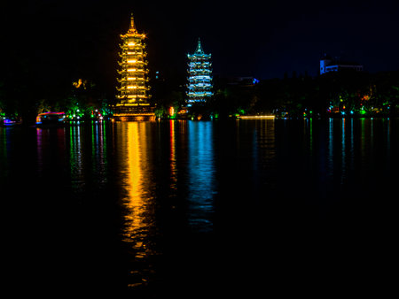 Night view of The Sun and Moon Pagodas on the Shan Lake. In Guilin, Chinaの写真素材