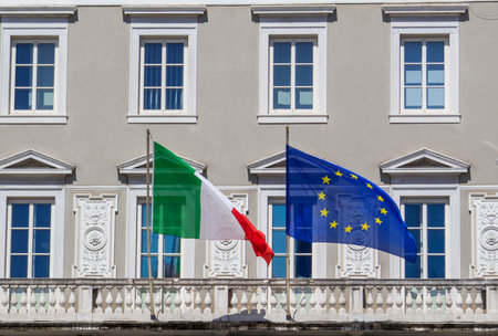 View of the Italian and European Union flags in the Unity of Italy Square. In Trieste, Italyの写真素材