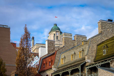 Old houses rooftops and clock tower of the old post office building - Quebec City, Canadaの写真素材