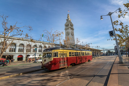 Street car or trollley or muni tram in front of San Francisco Ferry Building in Embarcadero - San Francisco, California, USAのeditorial素材