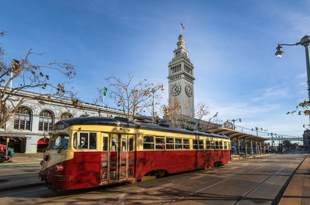 Street car or trollley or muni tram in front of San Francisco Ferry Building in Embarcadero - San Francisco, California, USAのeditorial素材