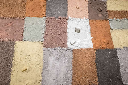 Texture of different colors of dry clay with stonesの写真素材
