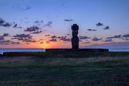 Ahu Tahai Moai Statue wearing topknot with eyes painted at sunset near Hanga Roa - Easter Island, Chileの写真素材