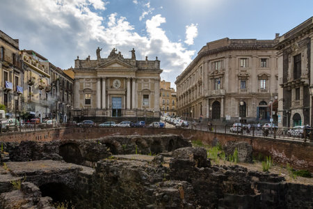 Ruins of the Roman Amphitheater at the Stesicoro Square with San Biagio Church on background - Catania, Sicily, Italyのeditorial素材