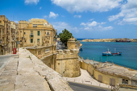 Cityscape view of Valletta and Grand Harbour with Victoria Gate and Ricasoli Fort on background - Valletta, Maltaのeditorial素材