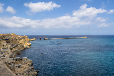 Valletta view of Grand Harbour with Breakwater Bridge and Lighthouse - Valletta, Maltaのeditorial素材