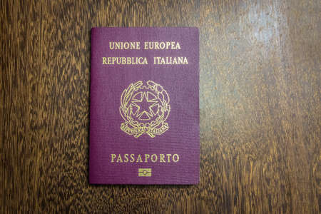 Italian passport on wooden backgroundの写真素材