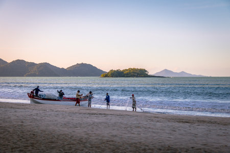 Fishermen at Beach with Island of Cabras Island on background - Balneario Camboriu, Santa Catarina, Brazilのeditorial素材