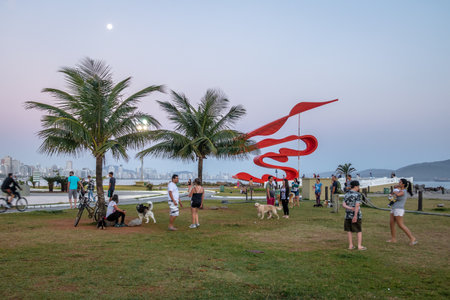 People having fun at sunset in the garden at Marine Outfall - Santos, Sao Paulo, Brazilのeditorial素材