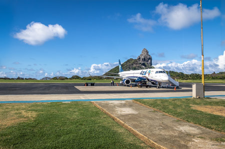 Airplane at Fernando de Noronha Airport with Morro do Pico on background - Fernando de Noronha, Pernambuco, Brazilのeditorial素材