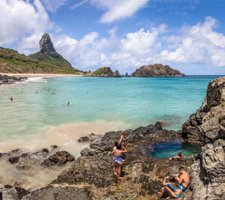 Buraco do Galego (Galego Hole) at Praia do Cachorro Beach with Morro do Pico on background - Fernando de Noronha, Pernambuco, Brazilのeditorial素材