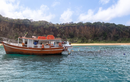 People swimming at Sancho Beach Beach during a boat tour - Fernando de Noronha, Pernambuco, Brazilのeditorial素材