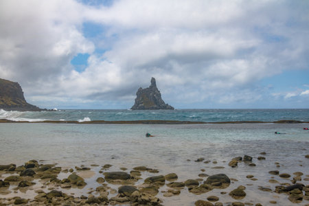 People snorkeling at Atalaia Beach with Morro do Frade on Background - Fernando de Noronha, Pernambuco, Brazilのeditorial素材