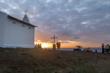 People watching the sunset at Chapel of Sao Pedro dos Pescadores - Fernando de Noronha, Pernambuco, Brazilのeditorial素材