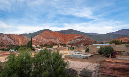 Panoramic view of Purmamarca town with the Hill of Seven Colors (Cerro de los siete colores) on background  - Purmamarca, Jujuy, Argentinaの写真素材