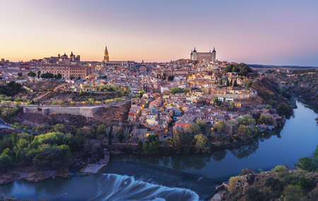 Beautiful view of Toledo city skyline with Cathedral, Alcazar and Tagus River at sunset - Toledo,...