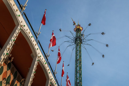 Copenhagen, Denmark - Jun 25, 2019: Star Flyer Ride (Himmelskibet) and Danish Flags at Tivoli Gardens Amusement Park - Copenhagen, Denmarkのeditorial素材