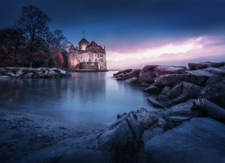 Montreux, Switzerland - Dec 04, 2019: Illuminated Chillon Castle and Lake Geneva at sunset - Canton of Vaud, Switzerlandのeditorial素材