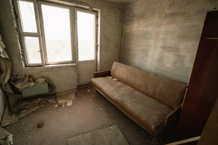 Chernobyl, Ukraine - Aug 07, 2019: Living room and sofa at an apartment in Pripyat - Pripyat, Chernobyl Exclusion Zone, Ukraineのeditorial素材