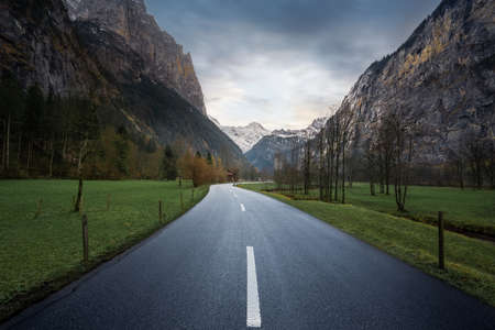 Road view leading straight into Bernese Alps Mountains - Lauterbrunnen, Switzerlandの写真素材