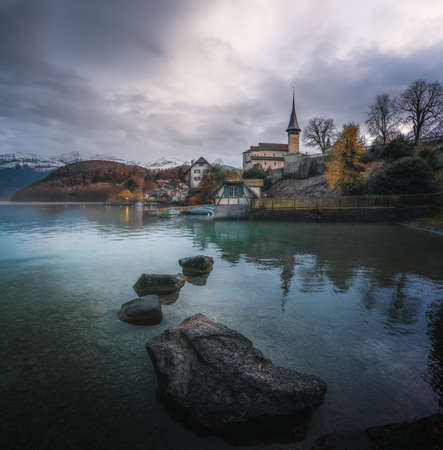 Rocks at Lake Thun and Spiez Castle Church (Schlosskirche) - Spiez, Switzerlandの写真素材