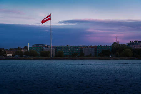 Sunset view of Latvian Flag on the West Bank of Daugava (Pardaugava) - Riga, Latvia