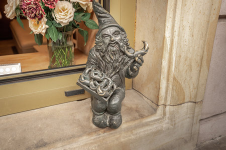 Wroclaw, Poland - Aug 20, 2019: Baker dwarf with croissants (Rogalik) - since 2005 hundreds of wroclaw dwarf figurines appeared in the city - Wroclaw, Polandのeditorial素材