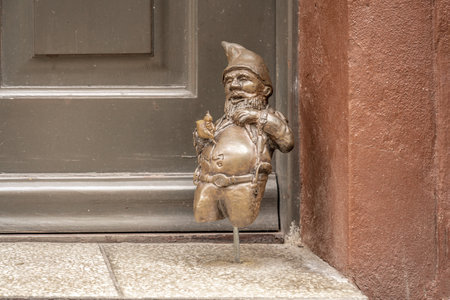 Wroclaw, Poland - Aug 21, 2019: Dwarf tattooing his own belly (Kostanty) - since 2005 hundreds of wroclaw dwarf figurines appeared in the city - Wroclaw, Polandのeditorial素材