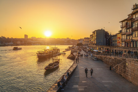 Porto, Portugal - Feb 4, 2020: Cais da Ribeira Waterfront and Douro River at Sunset - Porto, Portugalのeditorial素材