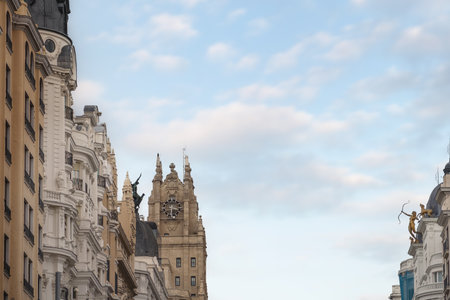 Madrid, Spain - Mar 23, 2019: Top of buildings at Gran Via Street with Diana the Huntress sculpture aiming at Phoenix and Endymion (or Ganymede) and Telefonica Building Tower - Madrid, Spainのeditorial素材