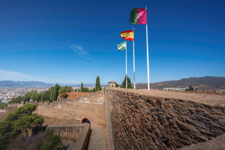 Malaga, Spain - May 18, 2019: Flags of Andalusia, Malaga Province and Spain at Gibralfaro Castle - Malaga, Andalusia, Spainのeditorial素材