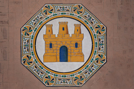 Seville, Spain - Apr 5, 2019: Tiles with Castile Coat of Arms at Plaza de Espana - Seville,...