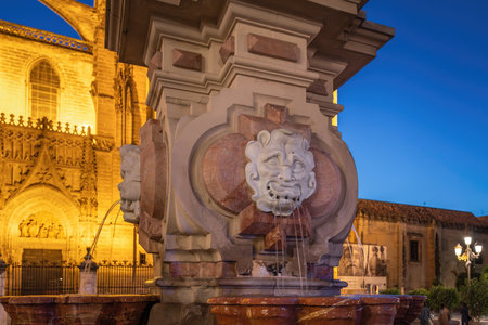 Seville, Spain - Apr 6, 2019: Fuente Farola Fountain at Plaza Virgen de Los Reyes Square - Seville, Andalusia, Spainのeditorial素材