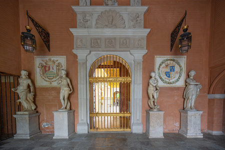 Seville, Spain - Apr 7, 2019: Golden door with statues at Casa de Pilatos (Pilates House) Palace Interior - Seville, Andalusia, Spainのeditorial素材