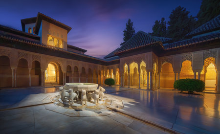 Granada, Spain - Jun 4, 2019: Illuminated Court of the Lions (Patio de los Leones) with fountain at Nasrid Palaces of Alhambra at night - Granada, Andalusia, Spainのeditorial素材