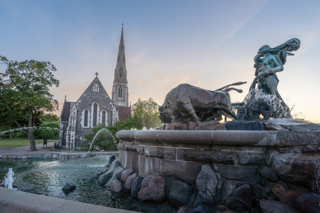 Copenhagen, Denmark - Jun 28, 2019: Gefion Fountain and St. Albans Church at Sunset - Copenhagen, Denmarkのeditorial素材