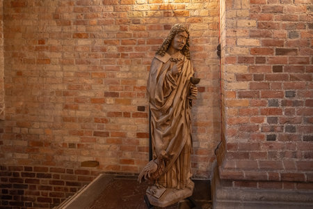 Roskilde, Denmark - Jun 25, 2019: Wooden Statue of John the Evangelist - Saint Birgitta Chapel at Roskilde Cathedral - Roskilde, Denmarkのeditorial素材